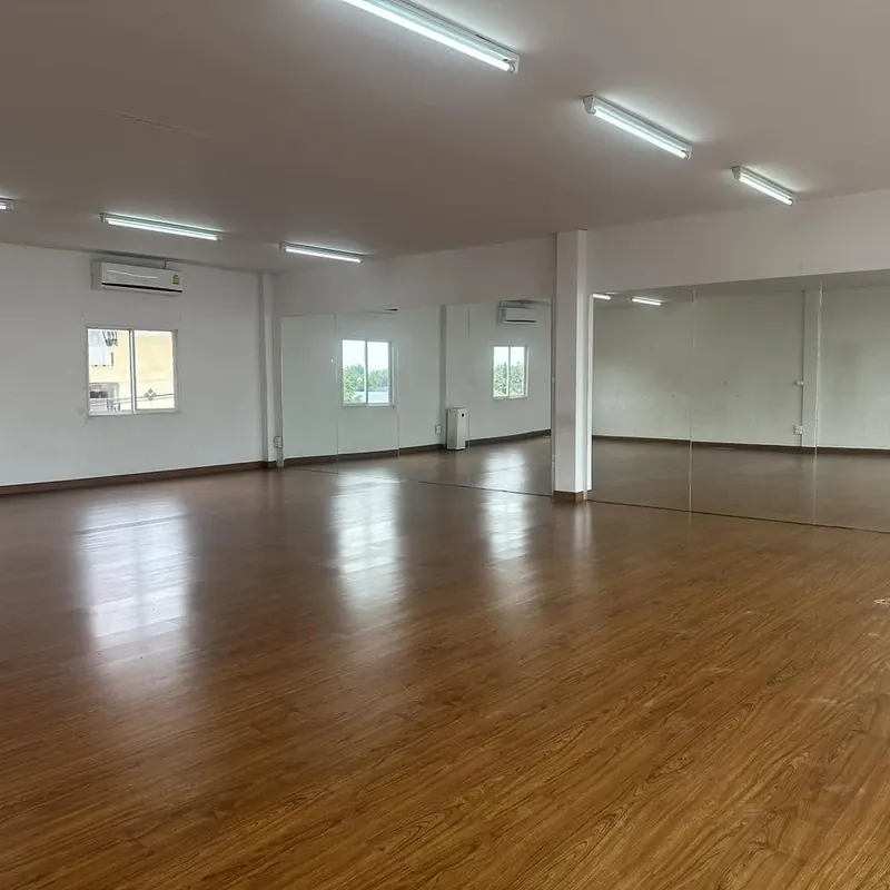 Mirrored wall and wooden floor under bright light